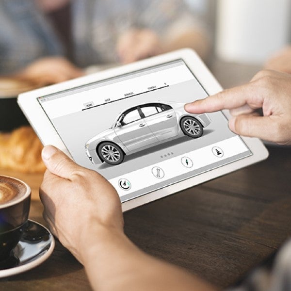 person selecting custom car on ipad